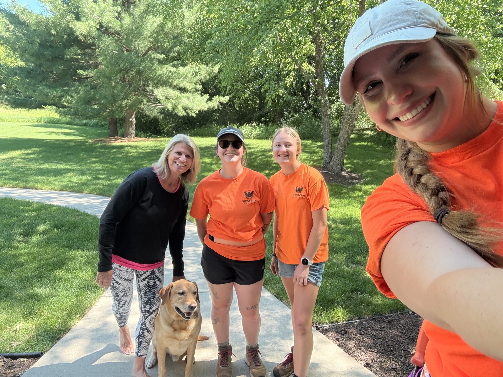 The Western Landscape team with a smiling customer and their dog